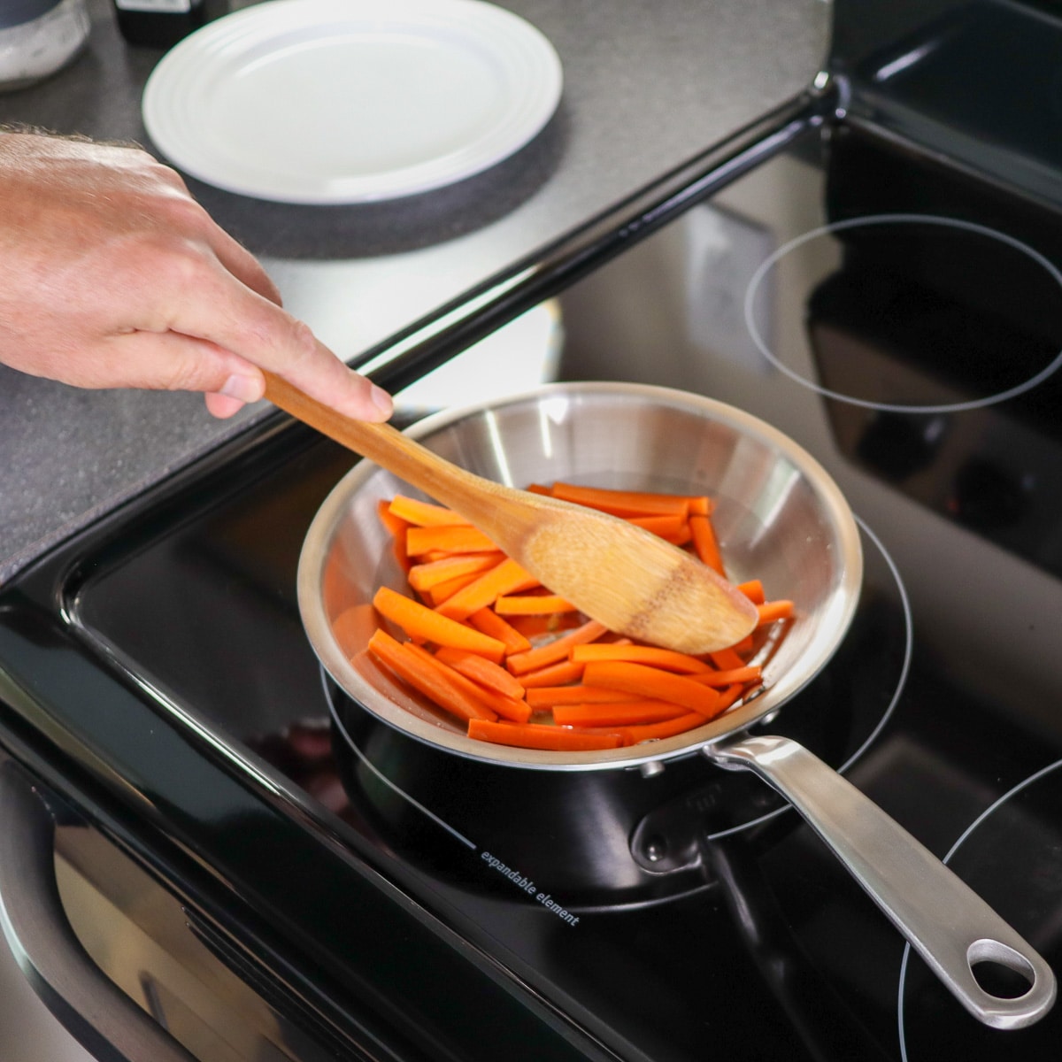 sauteing carrots in a pan