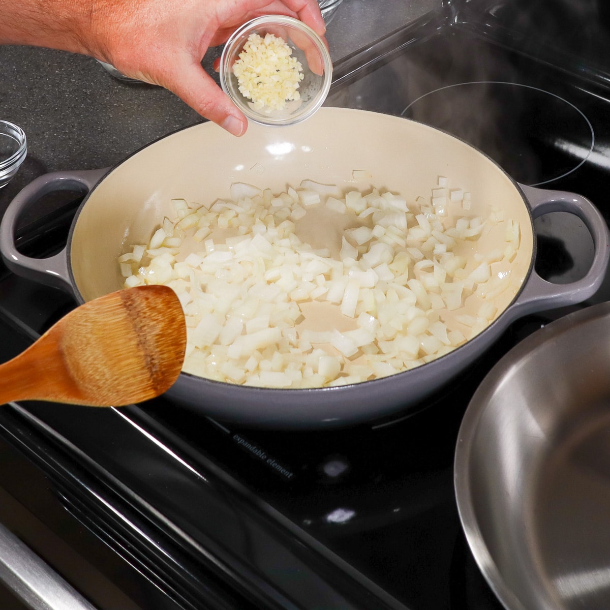 sauteing onions in garlic in pan