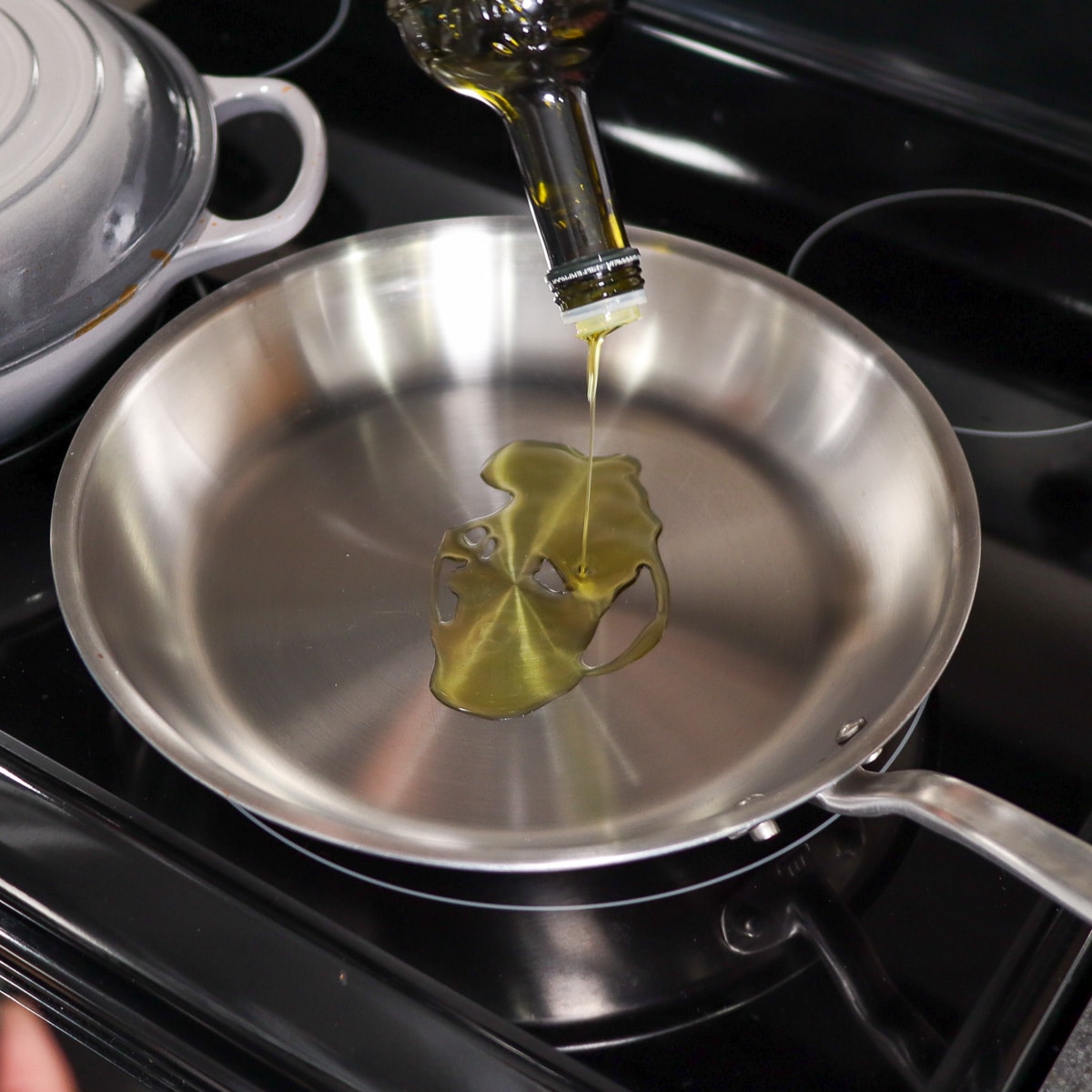 oil being added to frying pan