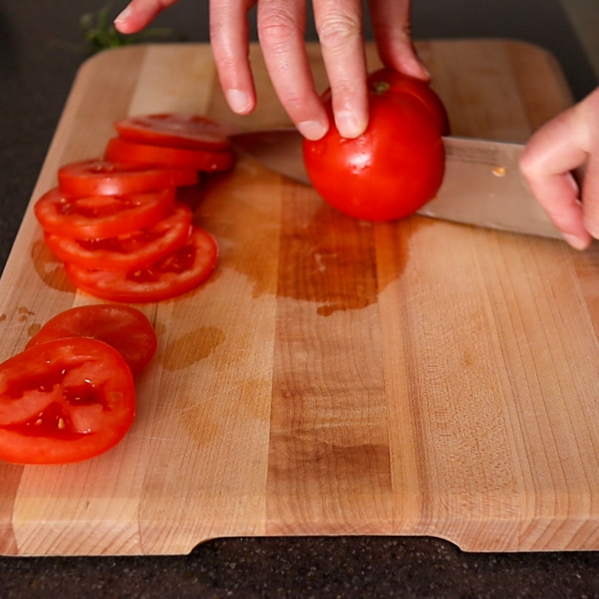 cutting tomatoes in half