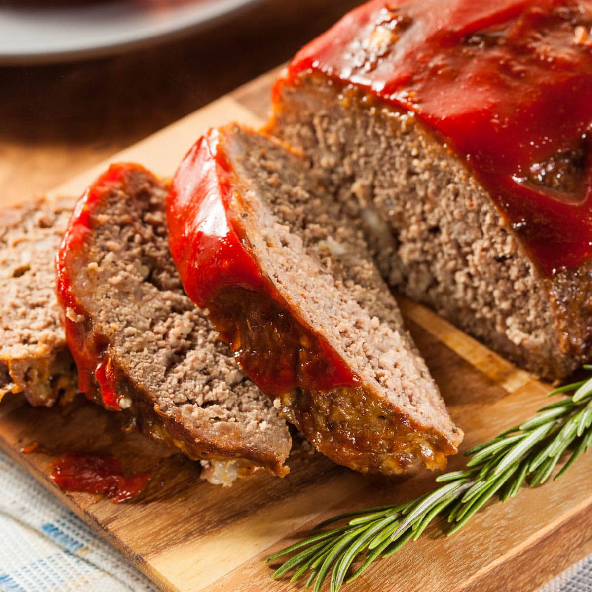 Meatloaf on a cutting board with 3 cut slices