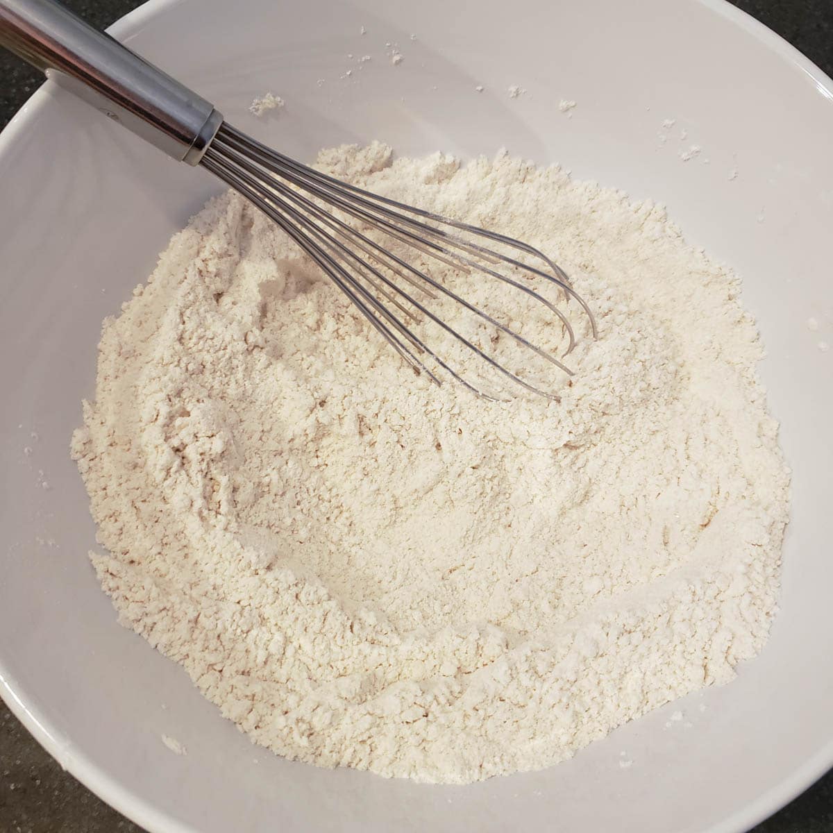 Dry ingredients in a mixing bowl with whisk.