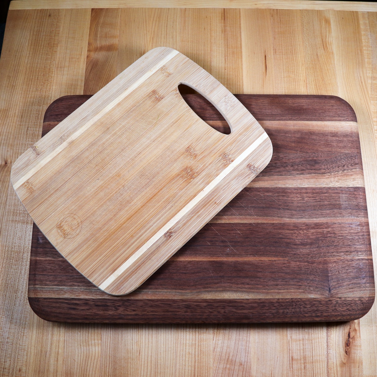 Three different sized cutting boards stacked on top of one another.