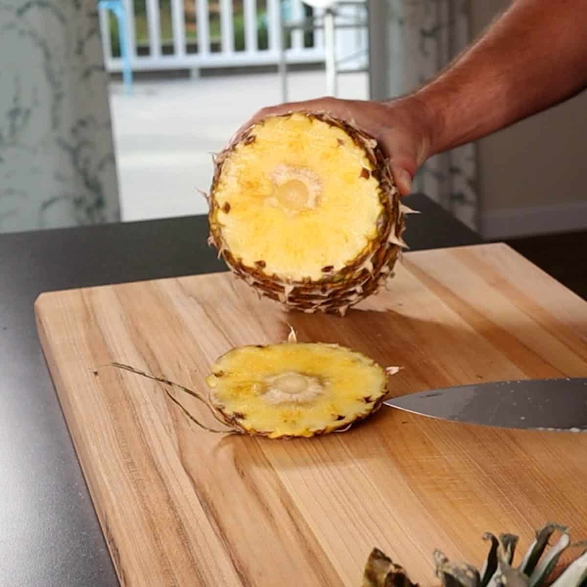 A whole pineapple with the bottom cut off