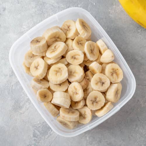 Plastic container of frozen sliced bananas