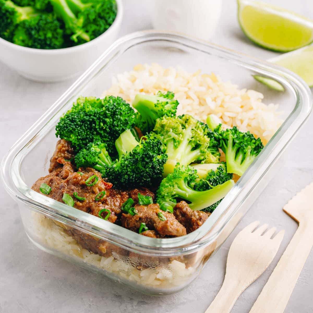 Leftover beef, broccoli and rice in a glass container.