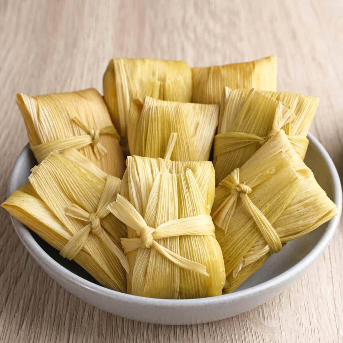 Bowl filled with tamales ready to be reheated.
