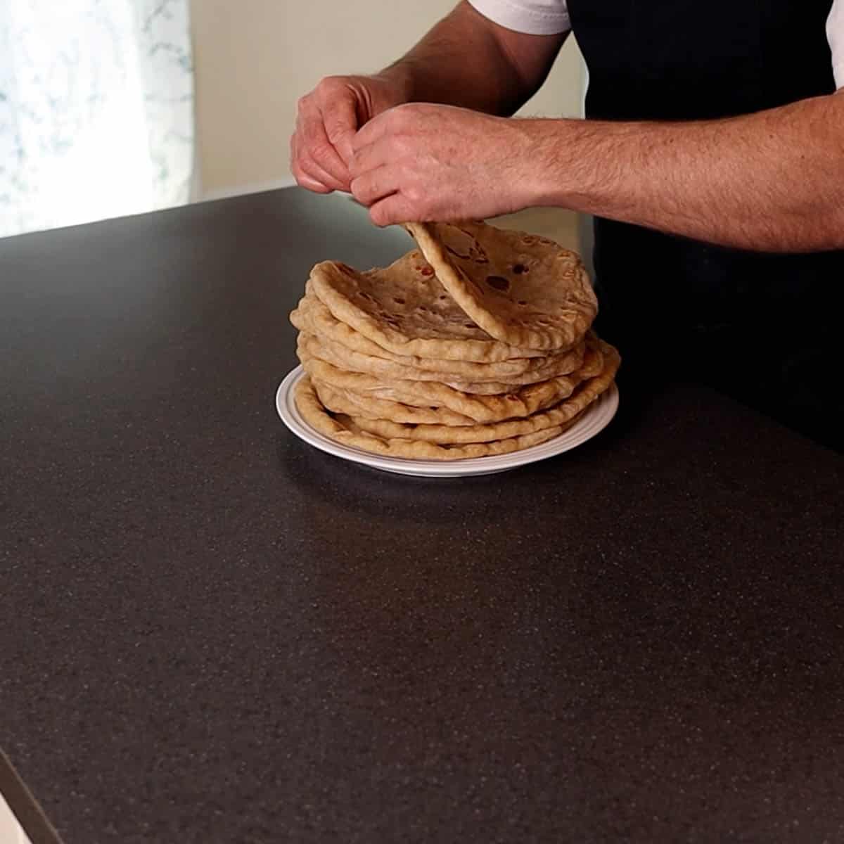 Stack of flatbreads on a white plate